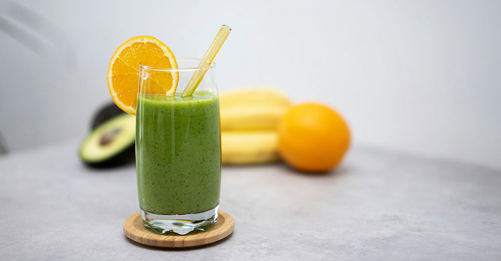 A-green-smoothie-in-a-glass-on-a-table-with-a-straw