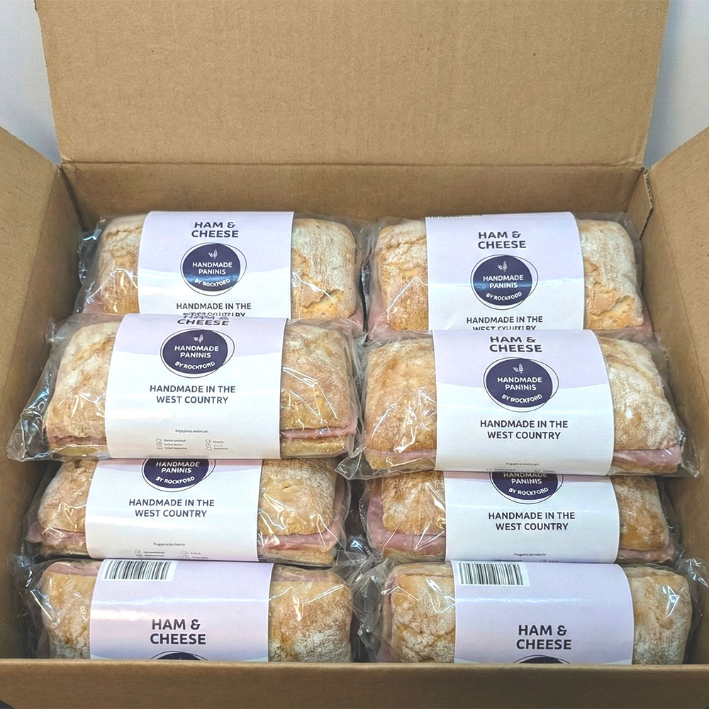 Hand and cheese paninis wrapped in a box