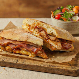 Hunters BBQ Chicken bacon panini with garden salad in the background